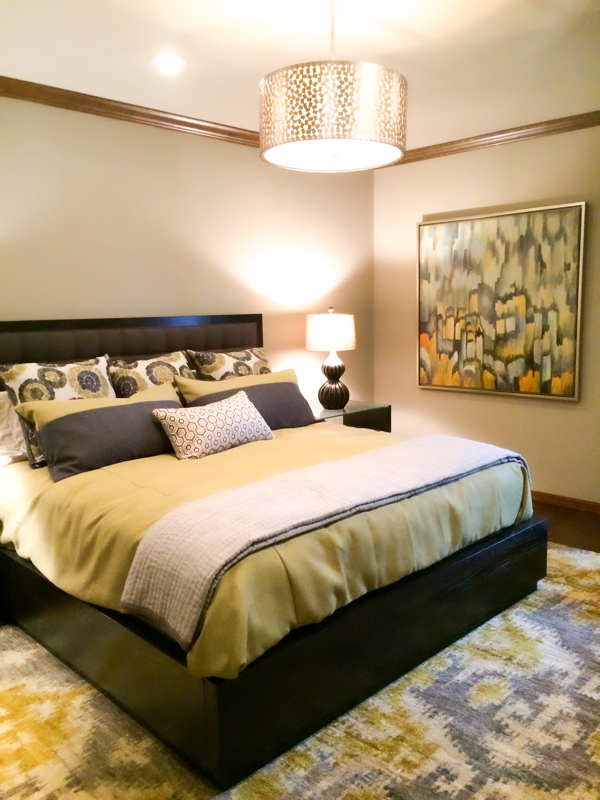 guest bedroom with yellow grey bedding and yellow and grey artwork