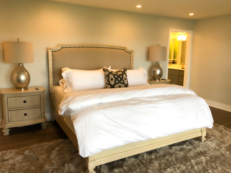 fabric headboard and white bedding and master bedroom 