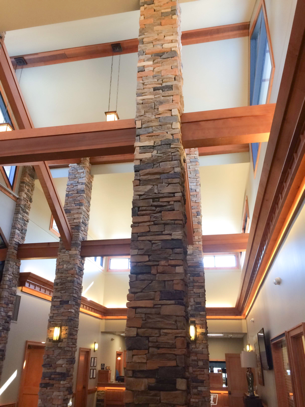 stone column and wood beams for a bank office design 