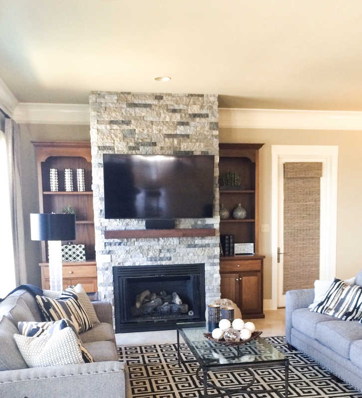 living room stone fireplace with two grey sofas 