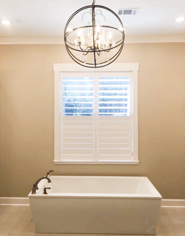 graber wood painted white shutter for window with chandelier and tub for a bathroom 