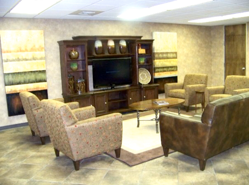 brown leather sofa and lounge chairs with tv center rug and coffee table commercial design