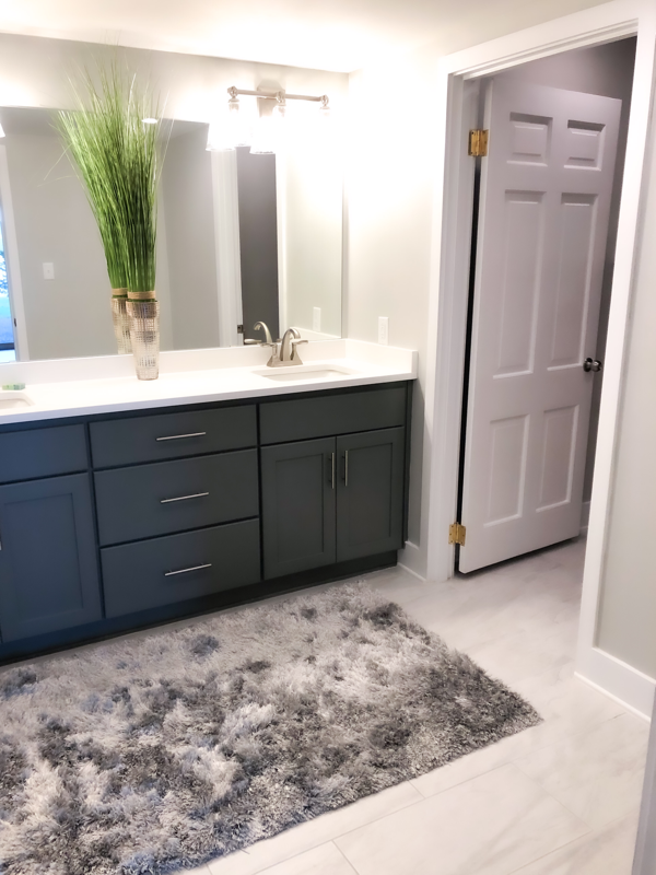 grey cabinets and white counter tops in guest bathroom 