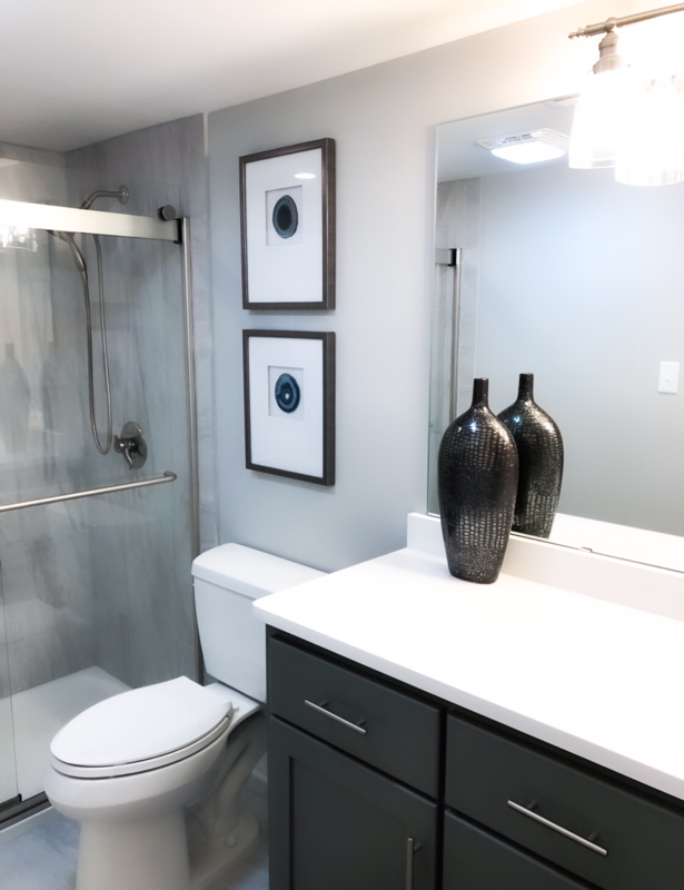 white and grey bathroom with brown vase