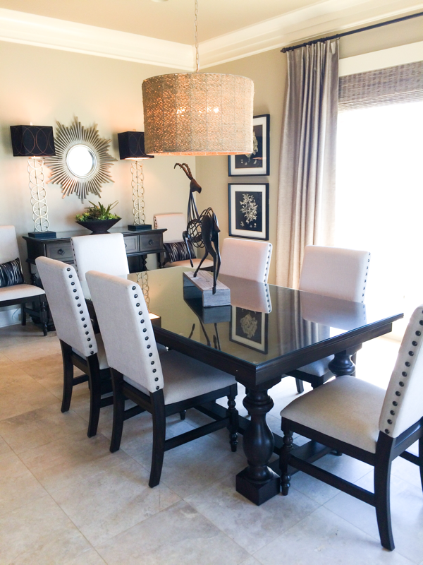 dining room table and chairs and credenza with silver lamps and black shades